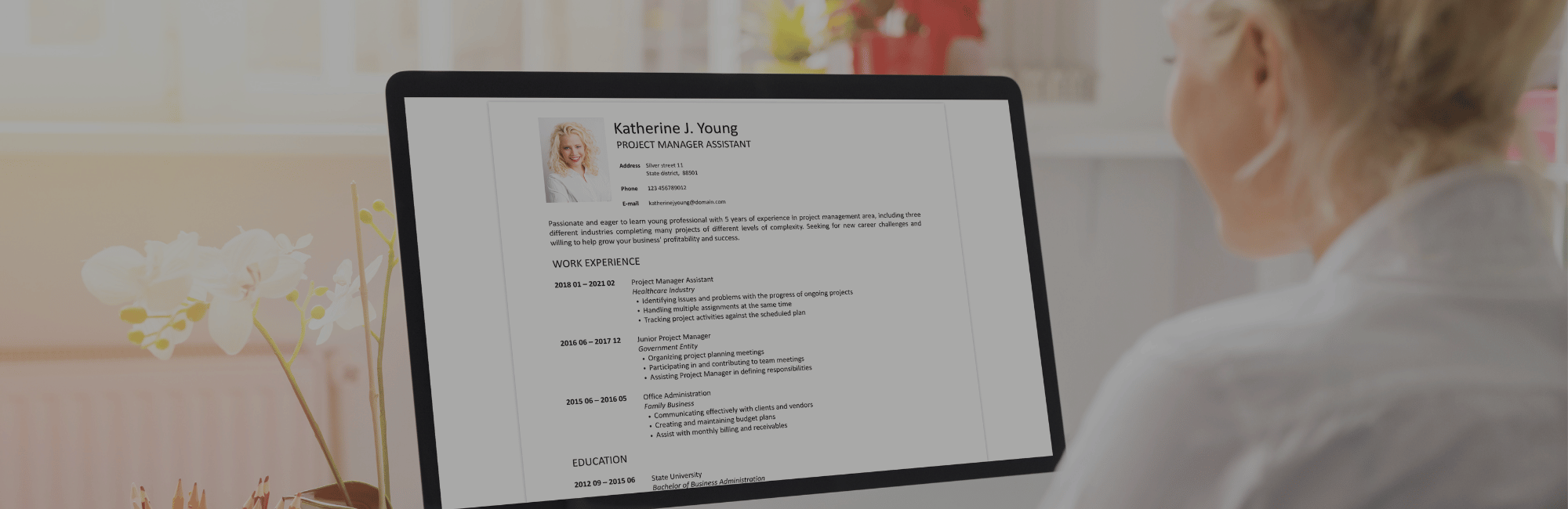 Women writing CV on mac