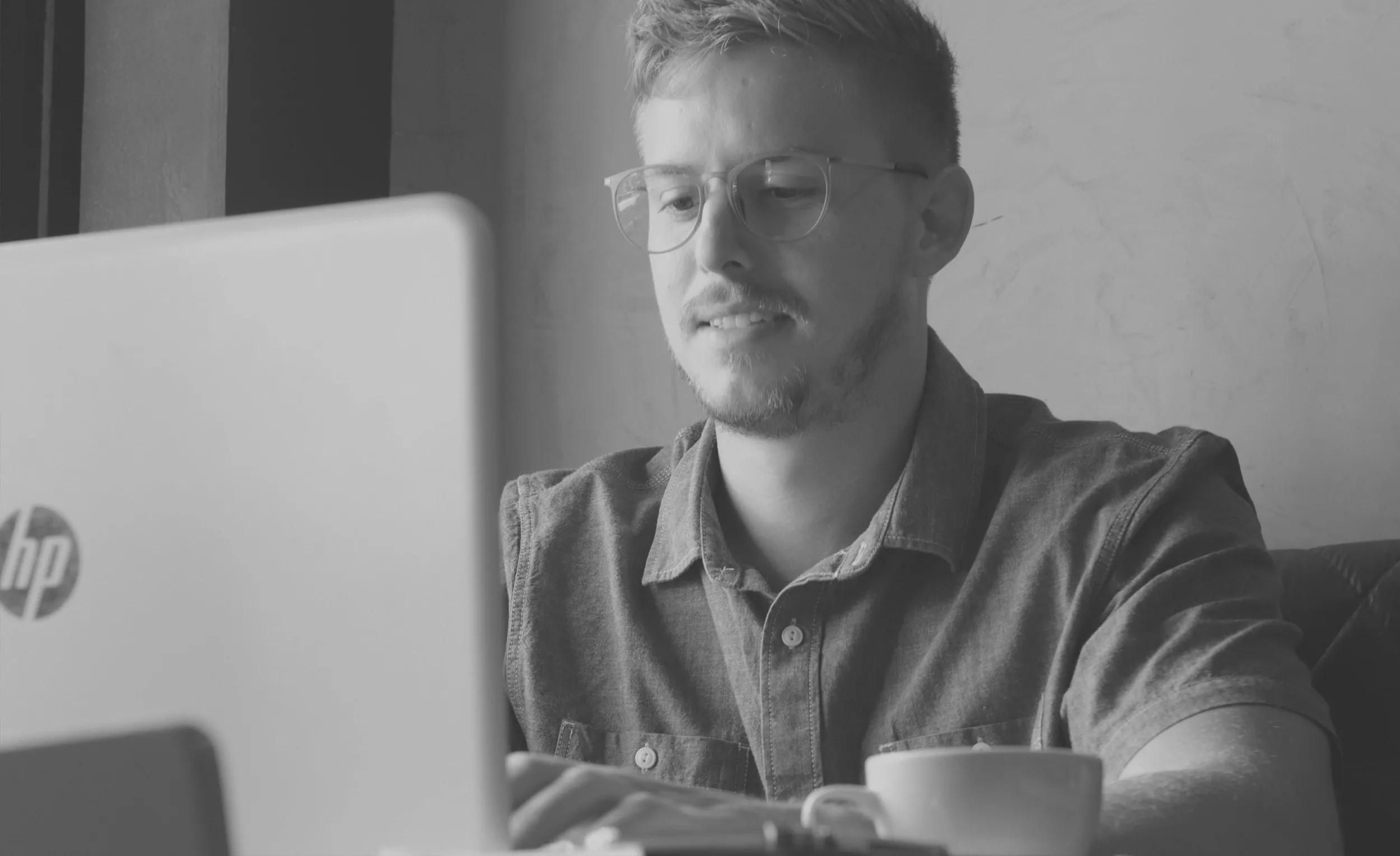 Man writing CV on laptop at home